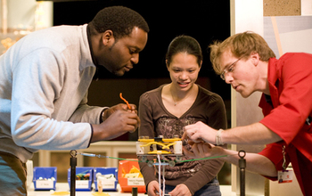 three people build a structure